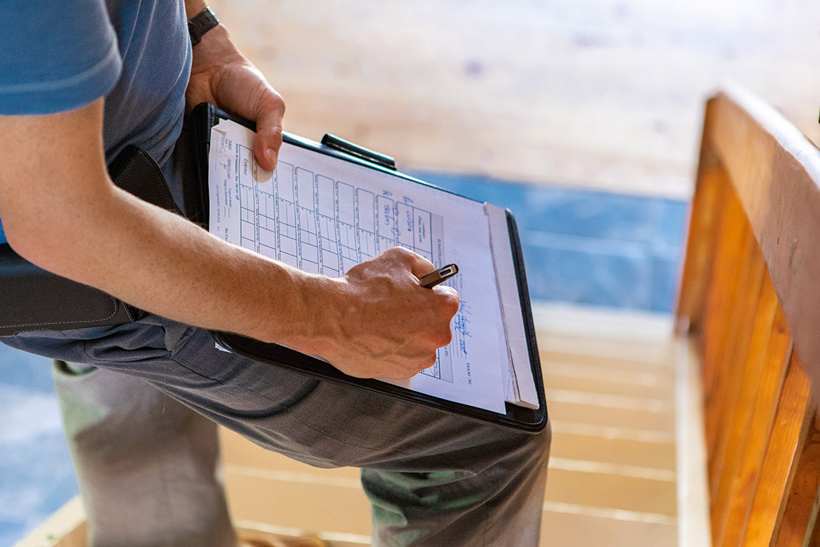 A man with a clipboard goes through a home inspections checklist