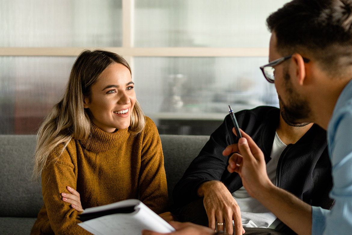 purchasing a home, man and woman talking with paperwork